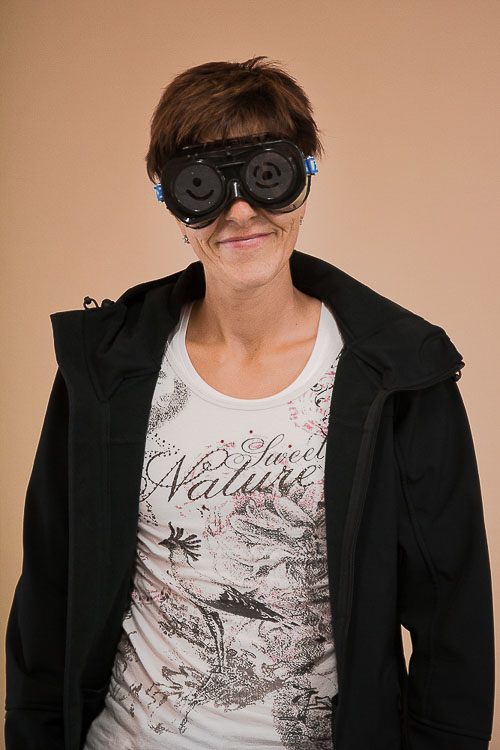 Foto: Von vorn dieselbe Seminarteilnehmerin mit Sehbehindertensimulationsbrille. Sie lächelt in die Kamera.
